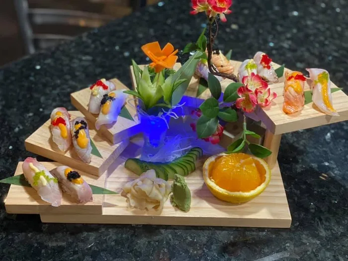 Sashimi platter with a rose-cut salmon garnish at Kasai